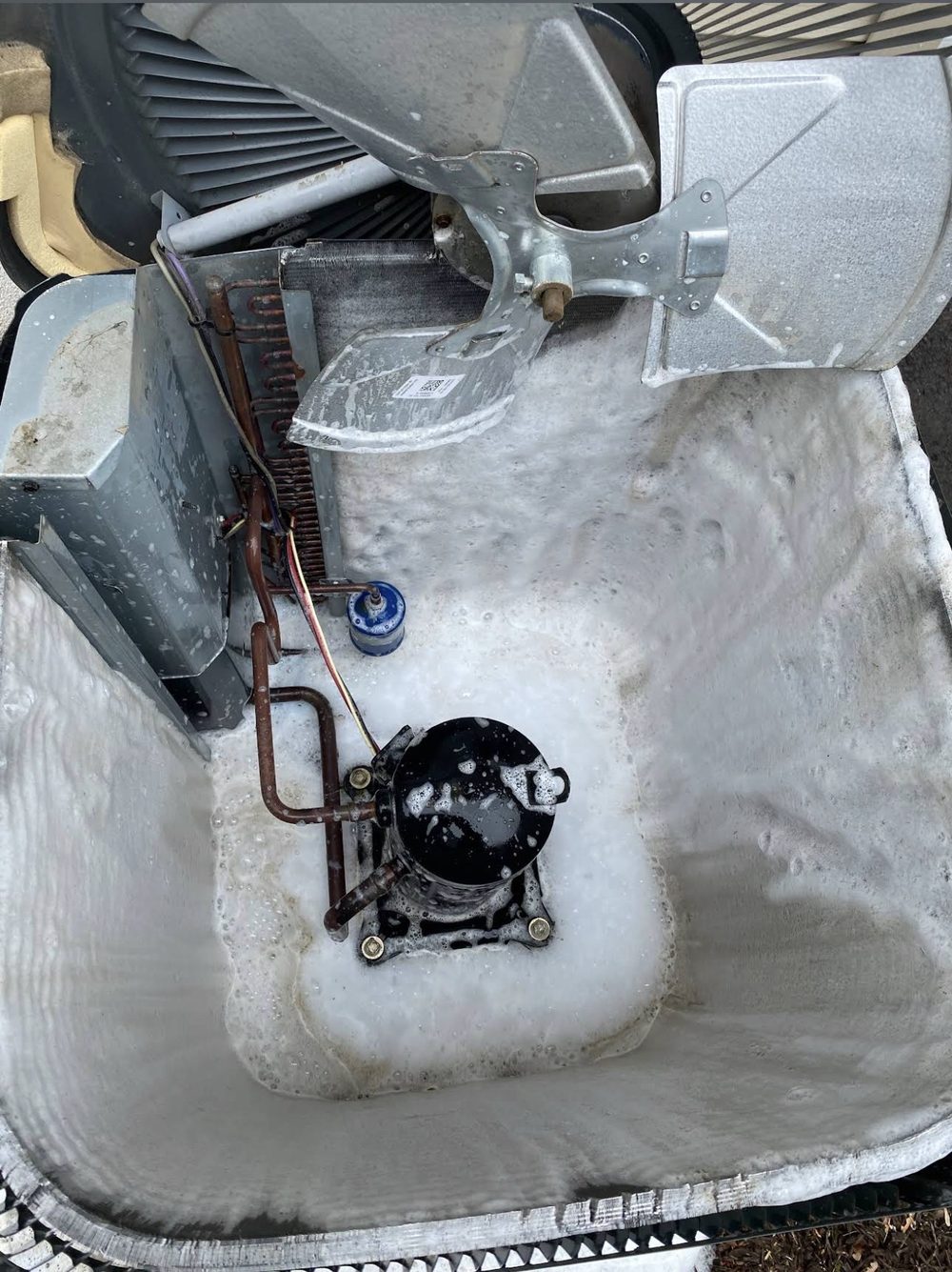 Foam-cleaning an air conditioner coil and compressor during a maintenance visit