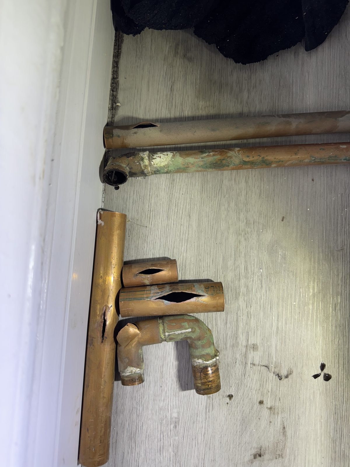 Burst copper water pipe removed during an emergency plumbing repair by Lumen Heating and Cooling
