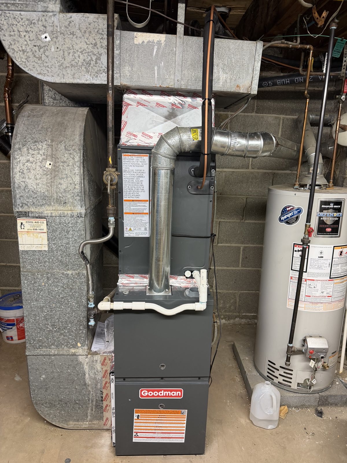 Goodman gas furnace and water heater installed in a crawlspace by Lumen Heating and Cooling
