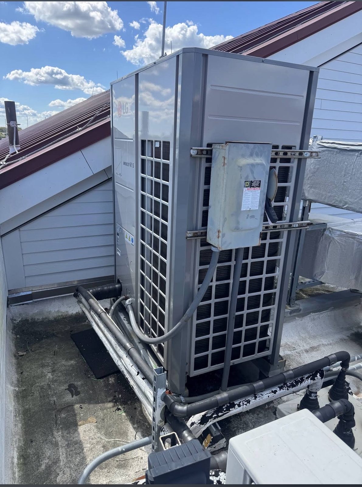 LG commercial VRF rooftop unit with electrical disconnect, installed by Lumen Heating and Cooling
