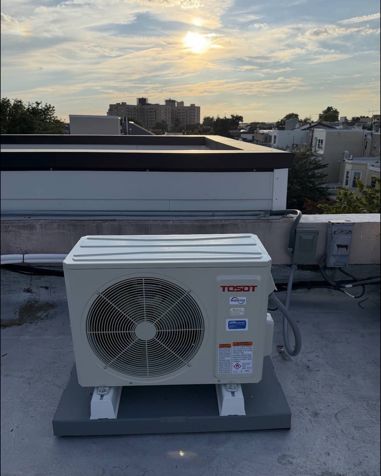 TOSOT inverter mini-split heat pump outdoor unit installed on a Philadelphia rowhome roof by Lumen Heating and Cooling